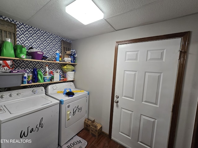 laundry area with dark wood finished floors, washing machine and dryer, wallpapered walls, baseboards, and laundry area