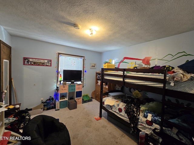 bedroom with a textured ceiling and carpet