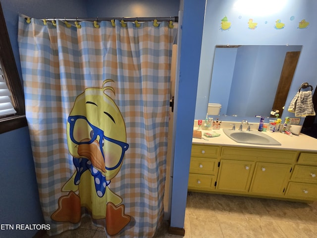 full bathroom with a shower with curtain, vanity, and tile patterned flooring