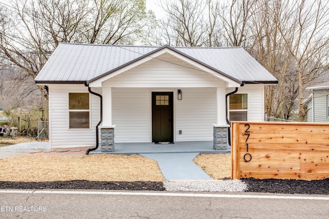 view of front of home with covered porch and metal roof