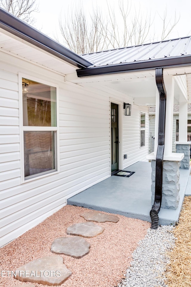 exterior space featuring metal roof, covered porch, and a standing seam roof