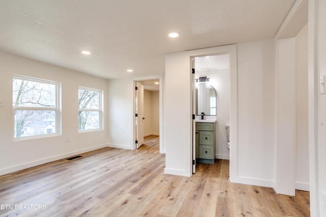 unfurnished bedroom featuring light wood-style flooring, recessed lighting, visible vents, and baseboards