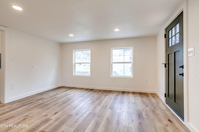 foyer entrance featuring recessed lighting, baseboards, and light wood finished floors