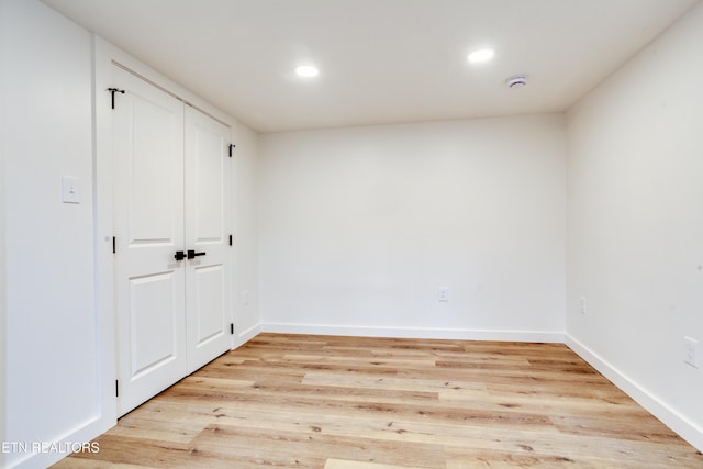 spare room with recessed lighting, baseboards, and light wood-style floors