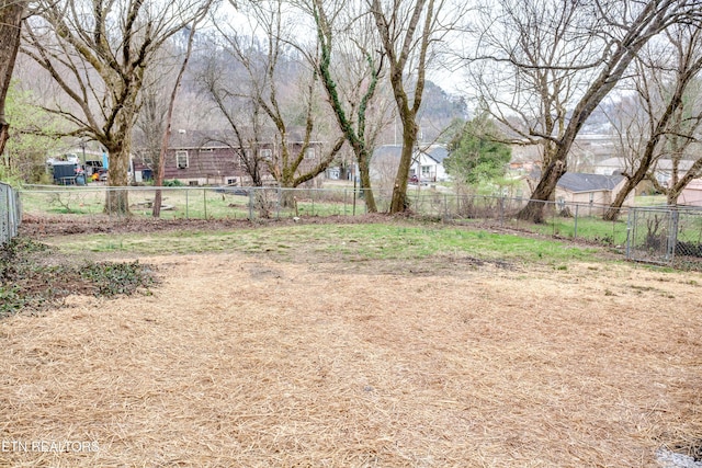 view of yard featuring fence and a residential view