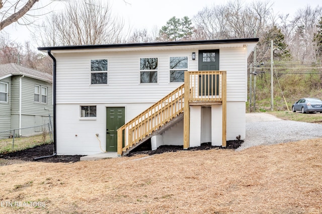 rear view of house with stairway and fence