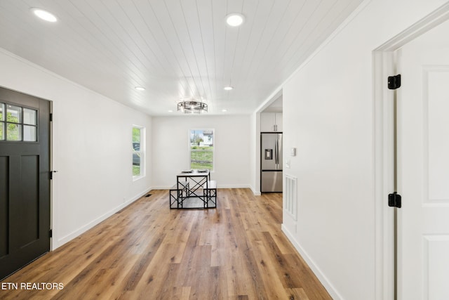foyer entrance featuring wooden ceiling, light wood-type flooring, baseboards, ornamental molding, and recessed lighting