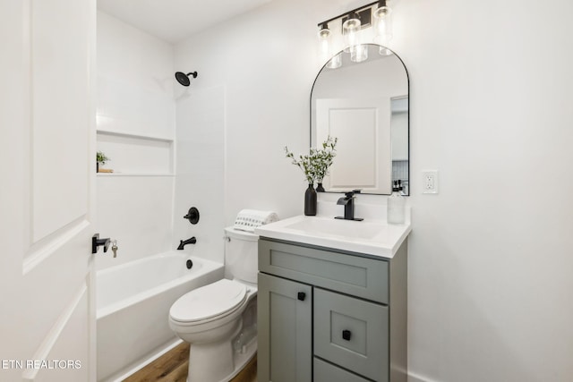 bathroom with toilet, vanity, and tub / shower combination
