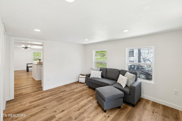 living room with baseboards, light wood-style floors, and recessed lighting