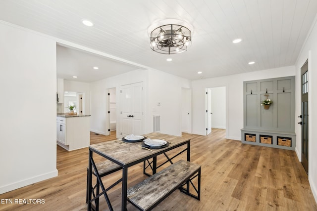 dining room with light wood finished floors, visible vents, recessed lighting, and a chandelier