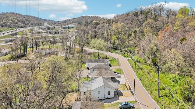 birds eye view of property with a forest view and a mountain view