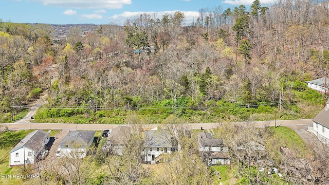 birds eye view of property with a wooded view