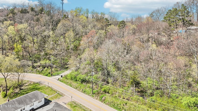 drone / aerial view featuring a view of trees