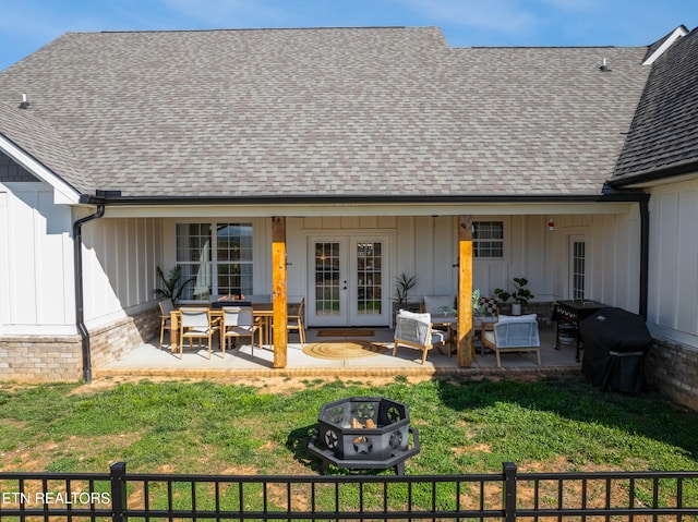 back of property featuring a patio, french doors, board and batten siding, a shingled roof, and fence private yard