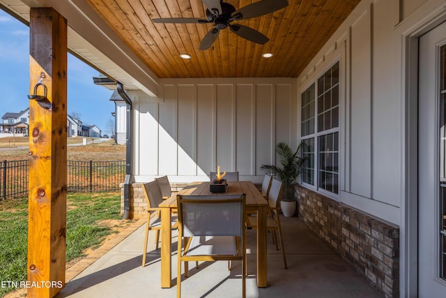 view of patio with outdoor dining space, ceiling fan, and fence