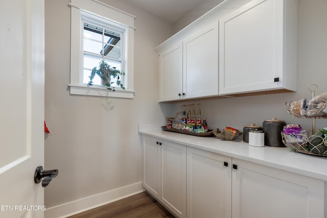 bar with baseboards and dark wood-style flooring