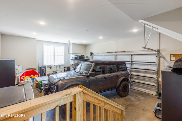 garage with recessed lighting and freestanding refrigerator