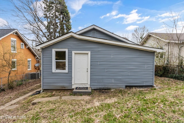 rear view of house featuring fence