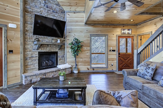 living area featuring a ceiling fan, wood finished floors, and wood ceiling