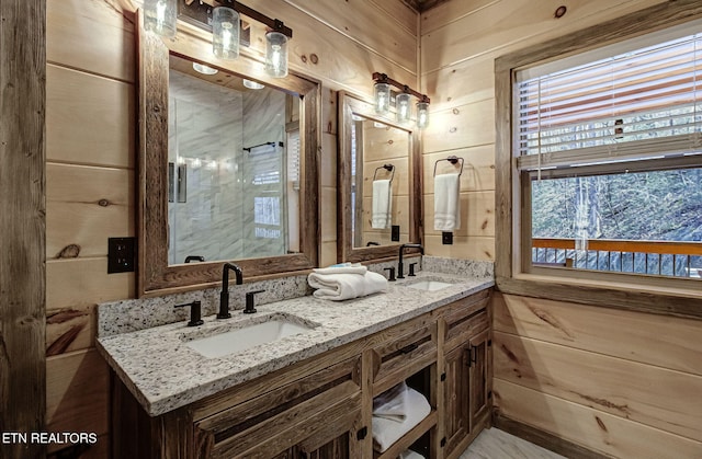 bathroom featuring a sink, wood walls, and double vanity