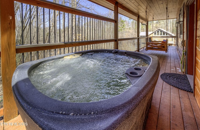 wooden deck featuring an outdoor hot tub