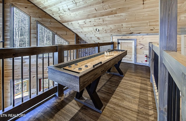 dining space featuring wood ceiling, wooden walls, wood finished floors, and high vaulted ceiling