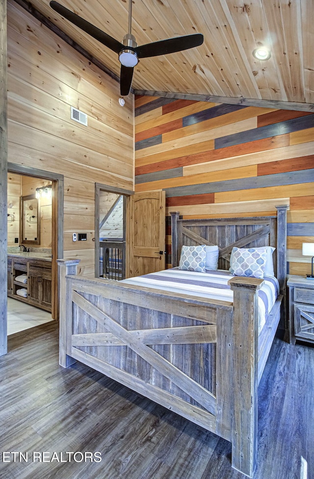 unfurnished bedroom featuring visible vents, wood walls, wood ceiling, wood finished floors, and high vaulted ceiling