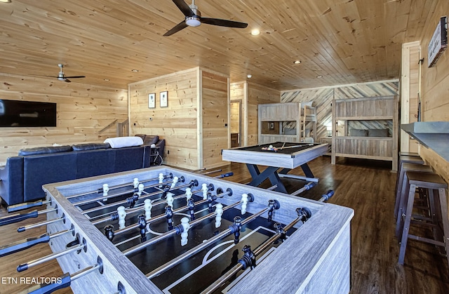 room details with wood finished floors, wooden ceiling, a ceiling fan, and wood walls