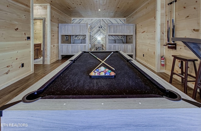 game room featuring wooden ceiling, wood finished floors, and wood walls