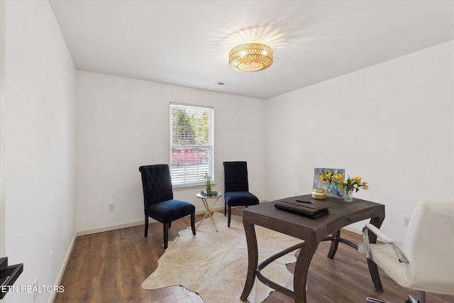 office area featuring visible vents, baseboards, and wood finished floors