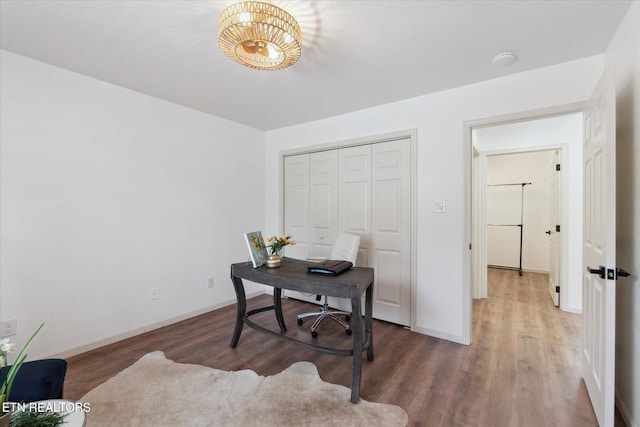 office space with baseboards and wood finished floors