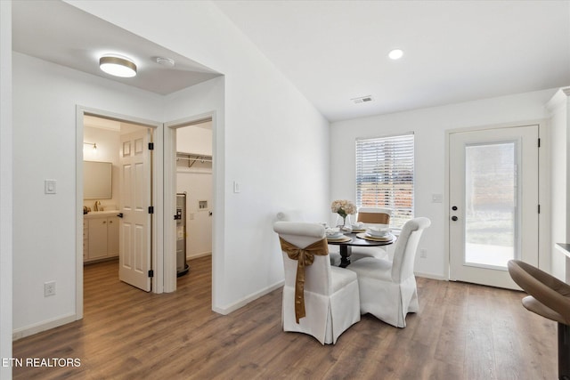 dining space with visible vents, baseboards, a healthy amount of sunlight, and wood finished floors