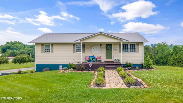 view of front of property featuring metal roof, a porch, and a front yard