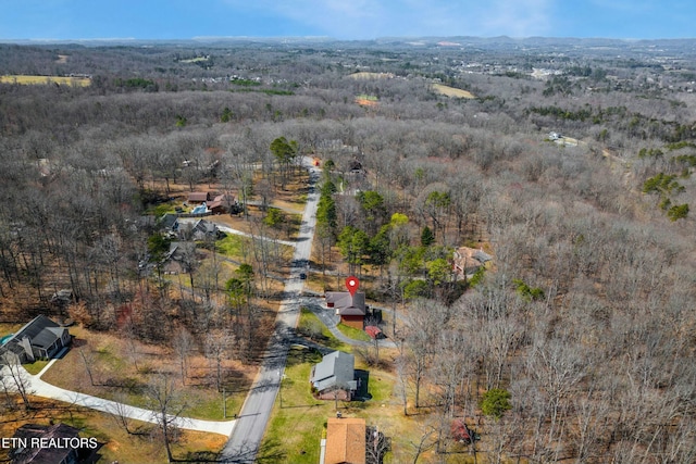 bird's eye view featuring a wooded view