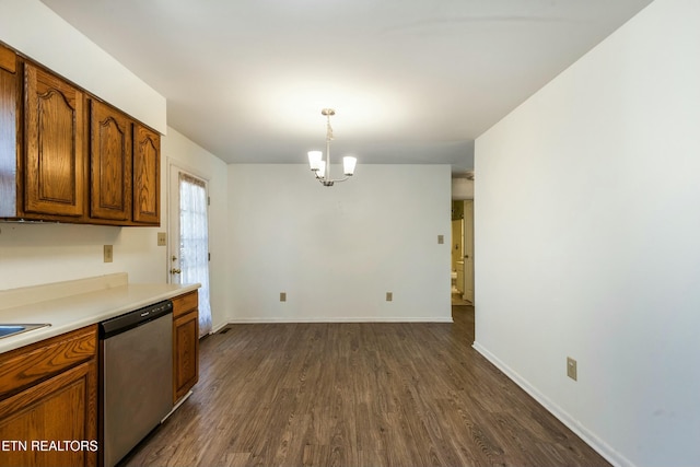 kitchen with dark wood finished floors, light countertops, brown cabinets, a notable chandelier, and stainless steel dishwasher