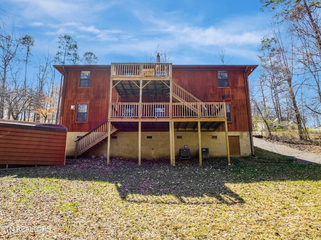 rear view of house with a wooden deck, stairs, a yard, crawl space, and a jacuzzi