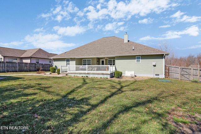 rear view of house featuring a lawn, a ceiling fan, a fenced backyard, crawl space, and a chimney