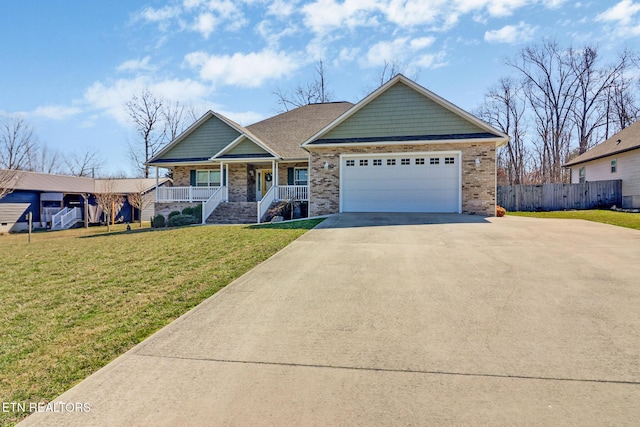 craftsman-style house with a front lawn, a porch, fence, concrete driveway, and an attached garage