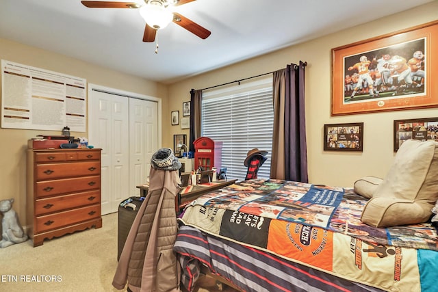 carpeted bedroom with a ceiling fan and a closet