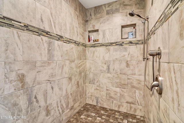 bathroom with tiled shower