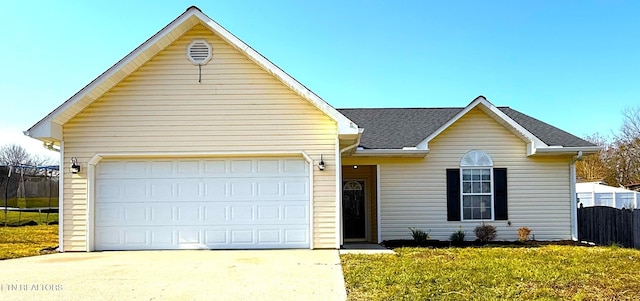 single story home with a front lawn, fence, concrete driveway, a shingled roof, and a garage