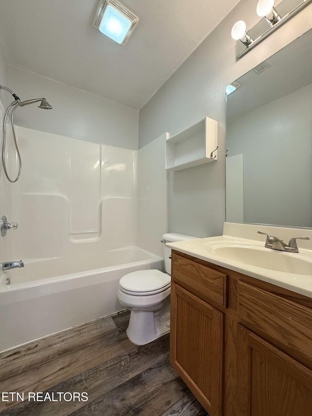 full bathroom featuring shower / washtub combination, toilet, vanity, and wood finished floors