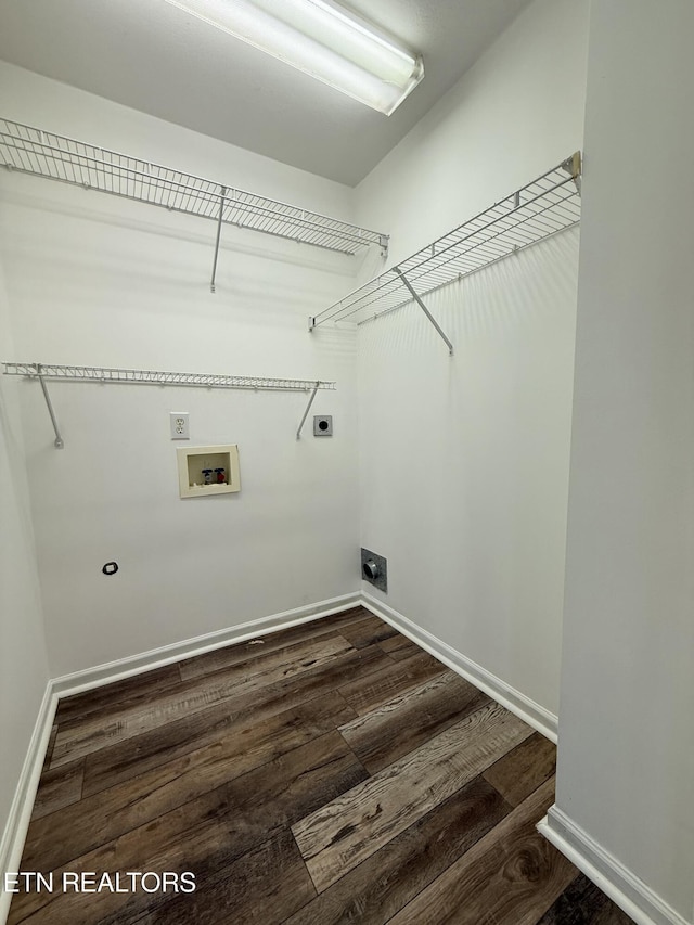 clothes washing area featuring dark wood finished floors, laundry area, hookup for a washing machine, and hookup for an electric dryer