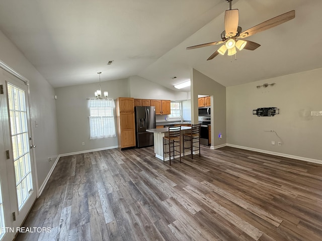 kitchen with dark wood finished floors, open floor plan, appliances with stainless steel finishes, and a center island