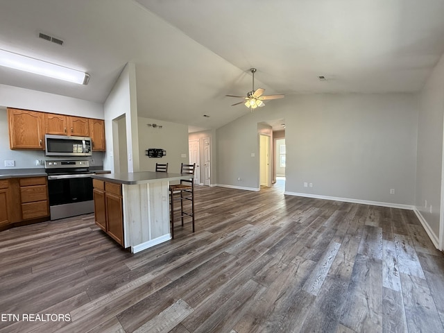 kitchen featuring dark wood finished floors, visible vents, appliances with stainless steel finishes, and a ceiling fan