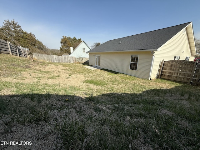 view of yard with a fenced backyard