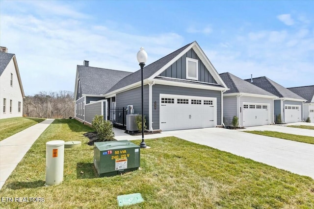 view of front of house featuring a front yard, driveway, a garage, central air condition unit, and board and batten siding