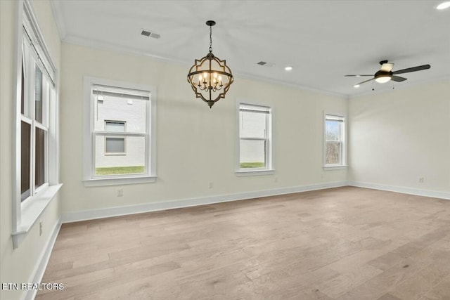 empty room with visible vents, baseboards, ornamental molding, and light wood-style flooring