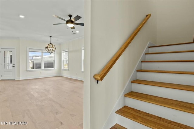 stairs featuring recessed lighting, ceiling fan with notable chandelier, and baseboards