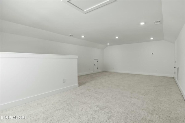 unfurnished room featuring vaulted ceiling, attic access, recessed lighting, and visible vents